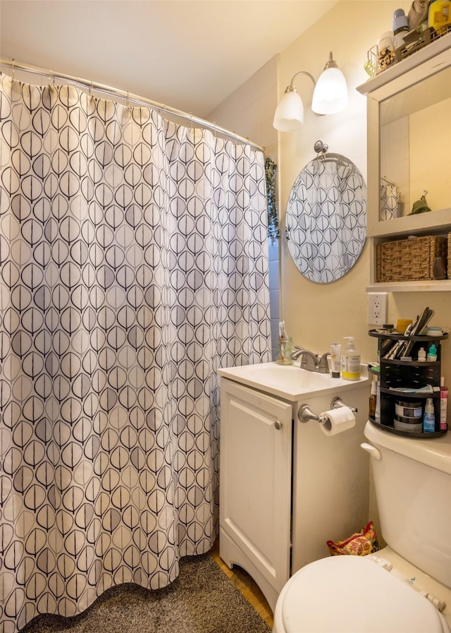 bathroom with vanity, toilet, and walk in shower