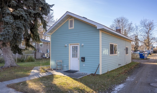 rear view of house featuring a yard