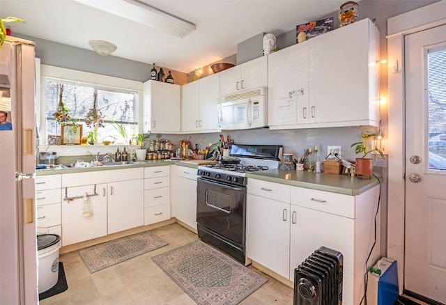 kitchen with white cabinetry, white appliances, and sink