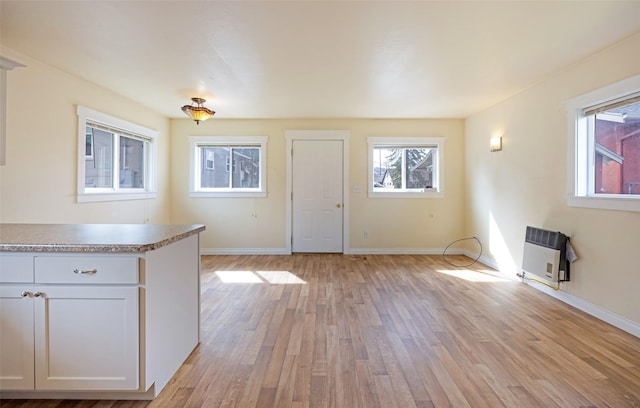 200 N Ave W, Missoula, MT 59801 - interior space with light wood finished floors, heating unit, and baseboards