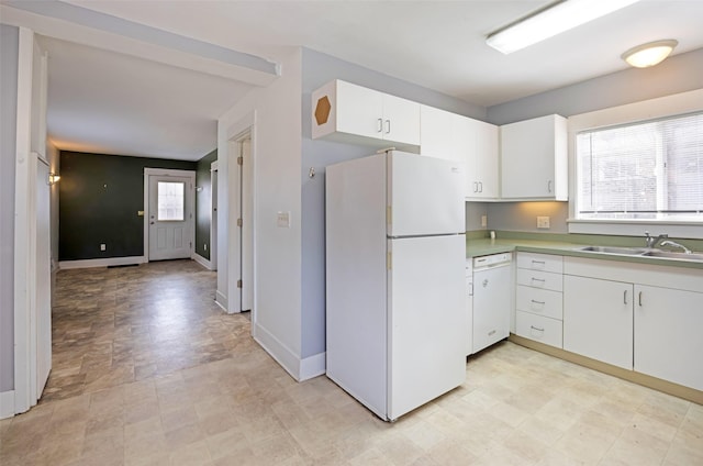 200 N Ave W, Missoula, MT 59801 - kitchen with a sink, white appliances, light countertops, white cabinets, and baseboards