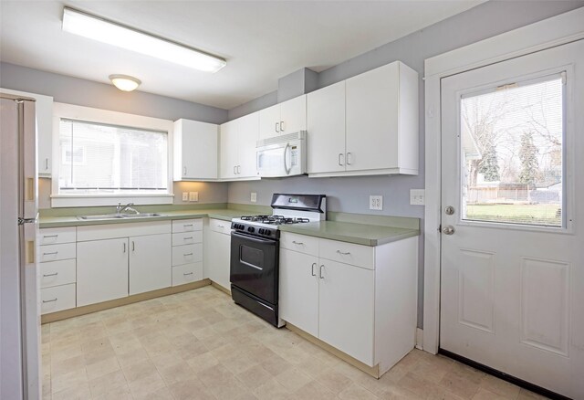 200 N Ave W, Missoula, MT 59801 - kitchen with white appliances, white cabinetry, and a healthy amount of sunlight
