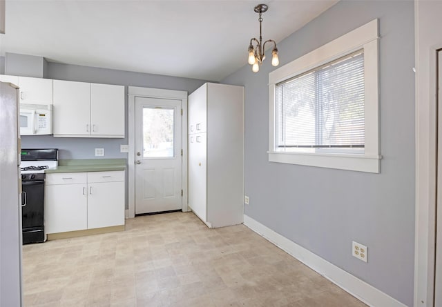 200 N Ave W, Missoula, MT 59801 - kitchen with gas range, white cabinets, a healthy amount of sunlight, and white microwave