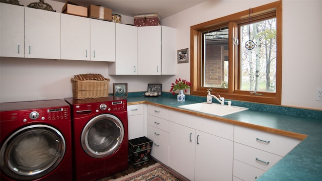 laundry room with cabinets, sink, and washing machine and clothes dryer