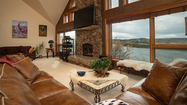 carpeted living room with a fireplace, a water view, and a high ceiling