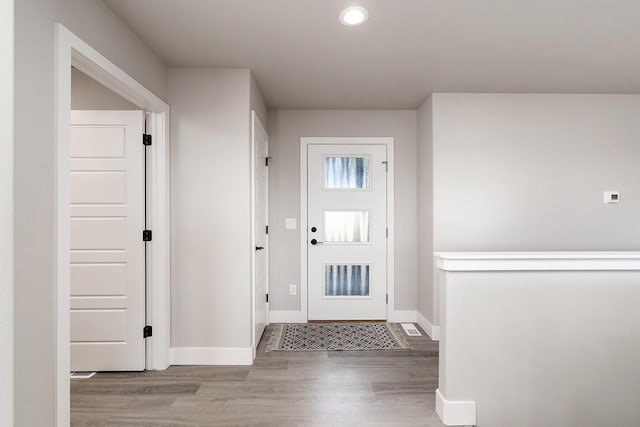 entryway with hardwood / wood-style floors