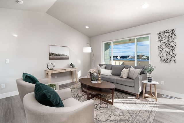 living room with hardwood / wood-style floors and lofted ceiling