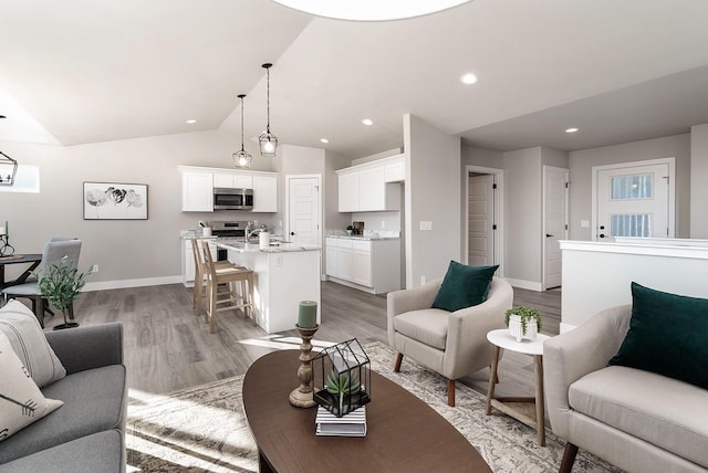 living room featuring light hardwood / wood-style floors and lofted ceiling