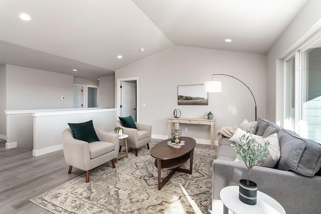 living room featuring light hardwood / wood-style floors and lofted ceiling