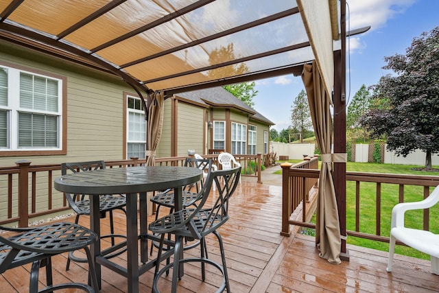 deck featuring a pergola and a yard