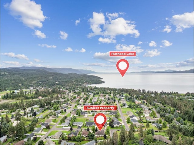 birds eye view of property featuring a water and mountain view