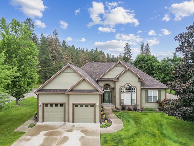 view of front of home with a front yard and a garage