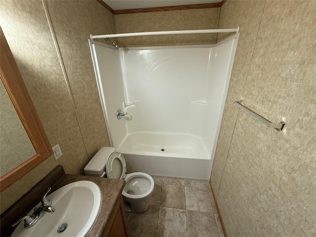 full bathroom with tile patterned floors, crown molding, toilet, shower / tub combination, and vanity