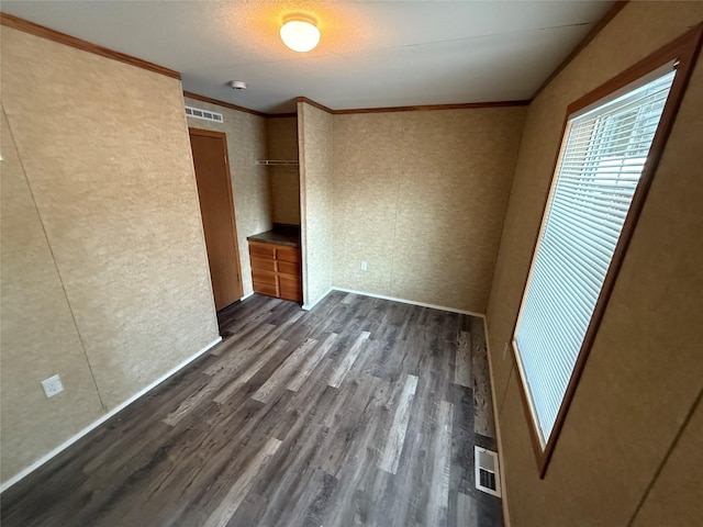 unfurnished bedroom featuring dark hardwood / wood-style flooring and ornamental molding