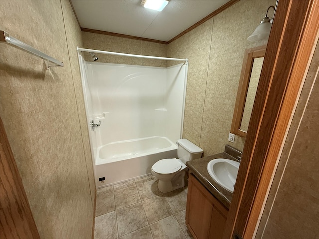 full bathroom featuring tile patterned floors, ornamental molding, vanity, bathing tub / shower combination, and toilet