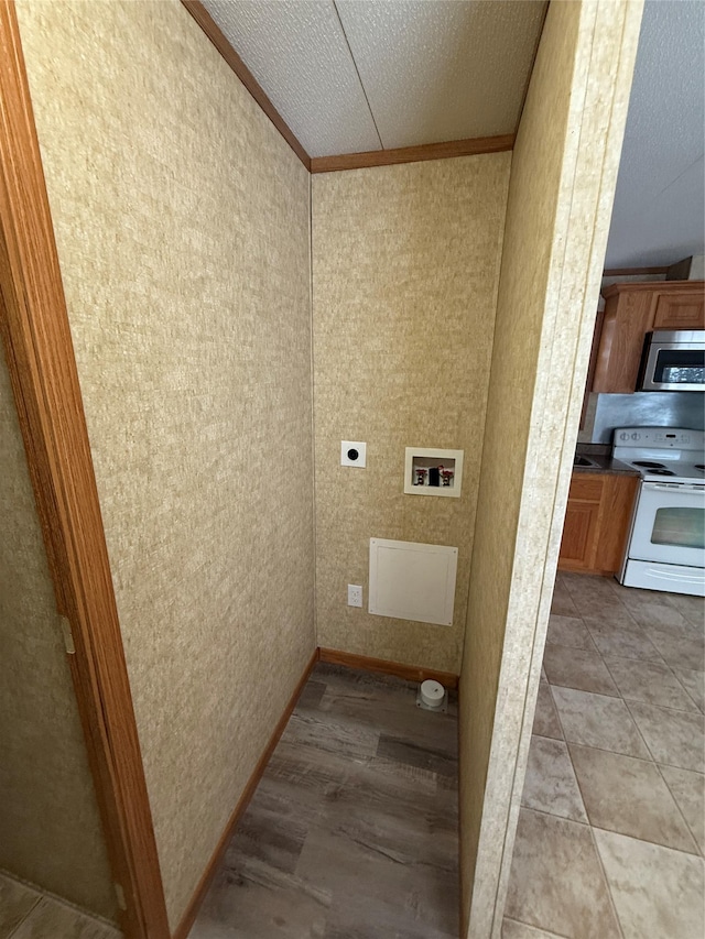 washroom featuring hookup for an electric dryer and ornamental molding