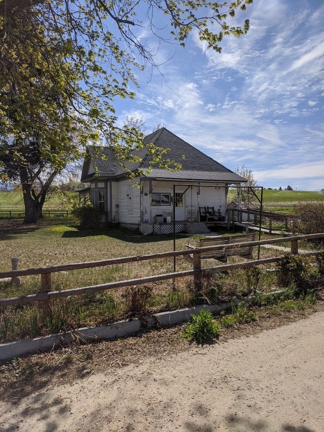 exterior space with a rural view and a porch