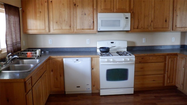 kitchen with white appliances, sink, and dark wood-type flooring