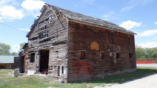 view of property exterior featuring an outbuilding