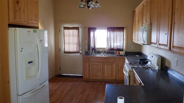 kitchen with white appliances, sink, dark hardwood / wood-style floors, light brown cabinetry, and a chandelier