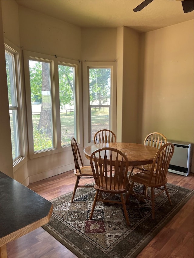 dining area featuring ceiling fan, hardwood / wood-style floors, and a healthy amount of sunlight