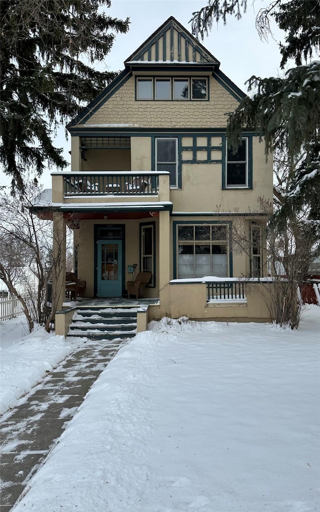 view of front of house with a balcony and covered porch