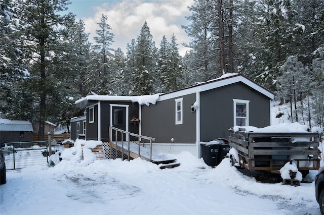 view of snow covered back of property