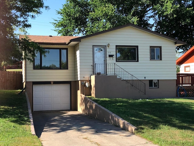 view of front of property featuring a garage and a front lawn