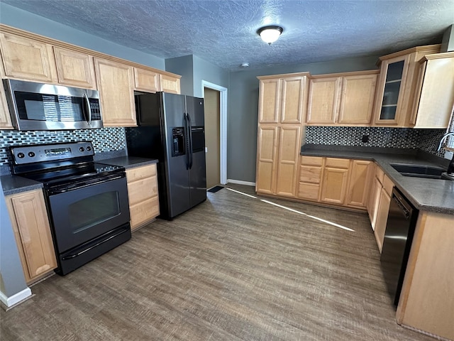 kitchen with black appliances, dark hardwood / wood-style flooring, sink, and light brown cabinetry