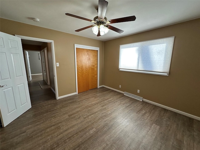 unfurnished bedroom with ceiling fan, a closet, and dark hardwood / wood-style floors