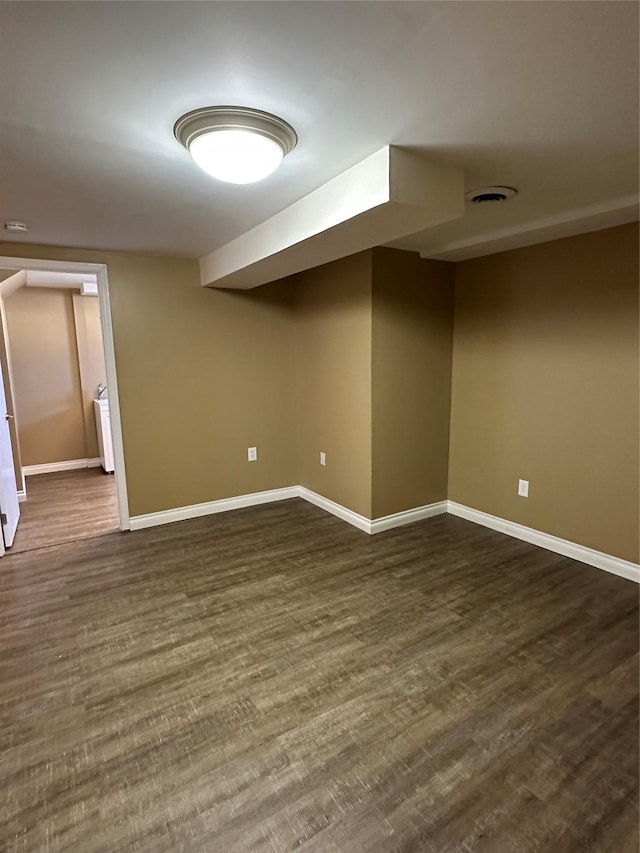 additional living space with dark hardwood / wood-style flooring