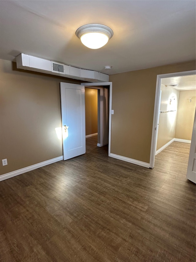 unfurnished bedroom with dark hardwood / wood-style floors and a closet