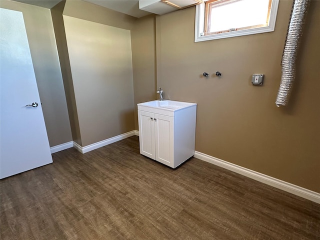 clothes washing area featuring dark hardwood / wood-style flooring and sink