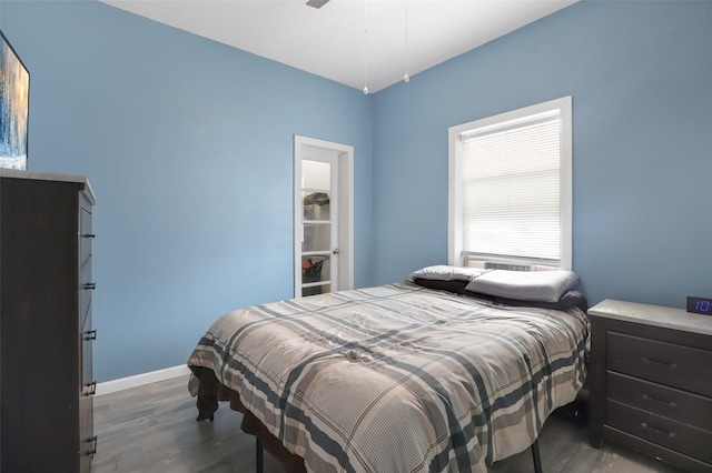 bedroom with dark wood-type flooring