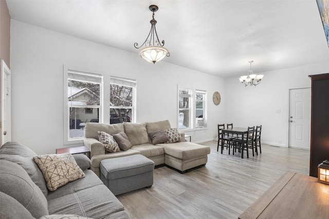 living room with a chandelier and light hardwood / wood-style floors