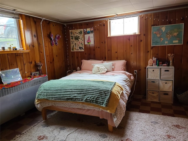 bedroom with radiator and wooden walls