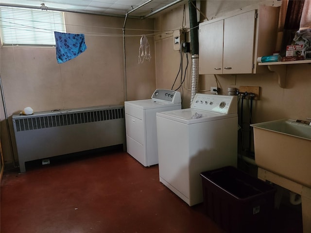 washroom with washer and dryer, cabinets, radiator heating unit, and sink