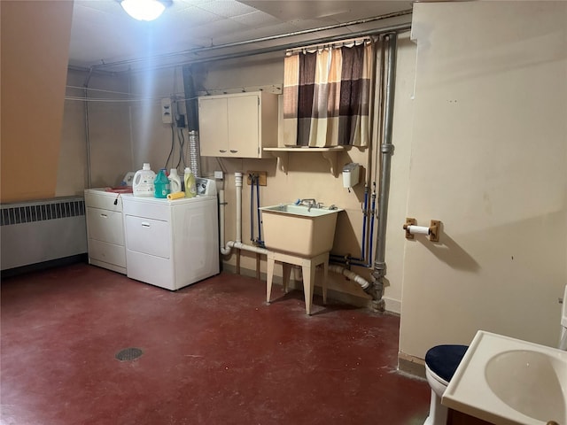 basement with washer and dryer, radiator heating unit, and sink