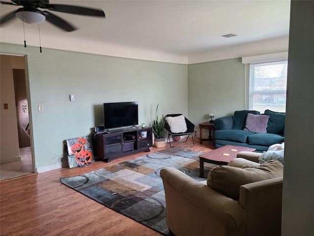 living room featuring hardwood / wood-style flooring and ceiling fan