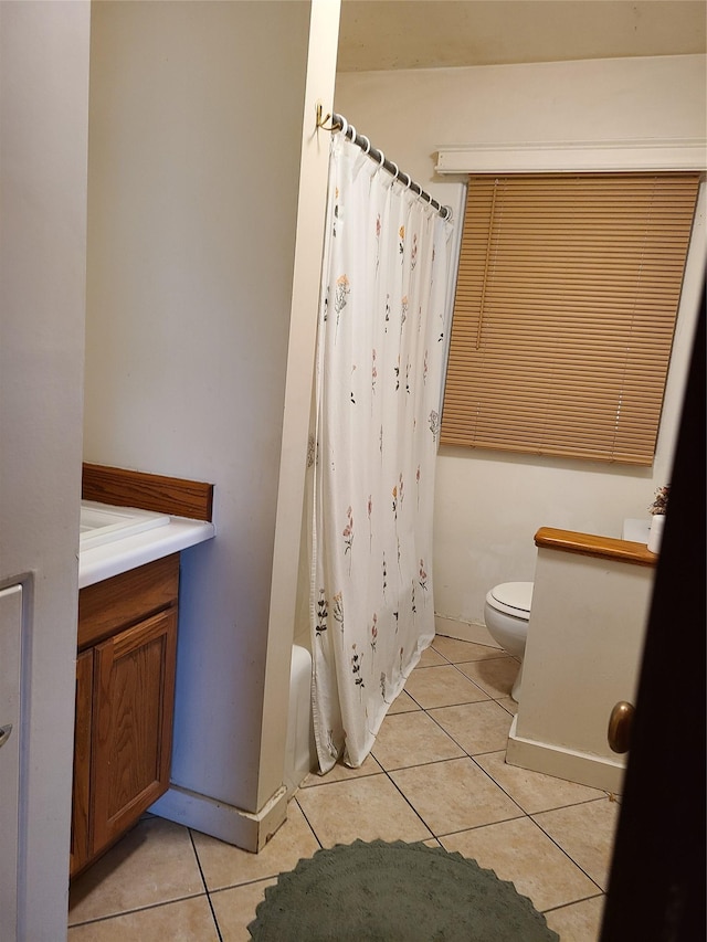 full bathroom featuring tile patterned flooring, vanity, shower / bath combo, and toilet