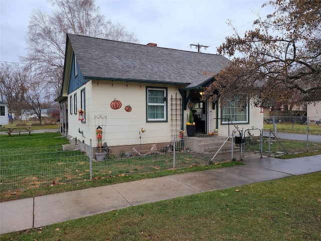 bungalow-style house featuring a front lawn