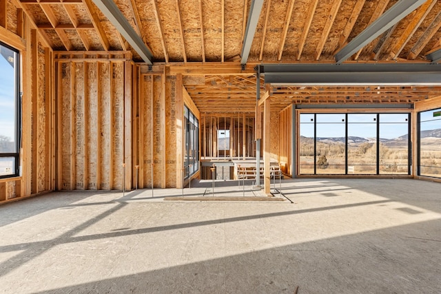 misc room with a mountain view and a healthy amount of sunlight