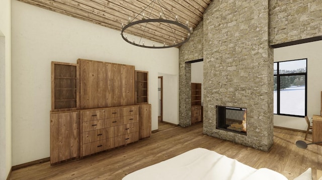 bedroom featuring hardwood / wood-style flooring, a fireplace, and high vaulted ceiling