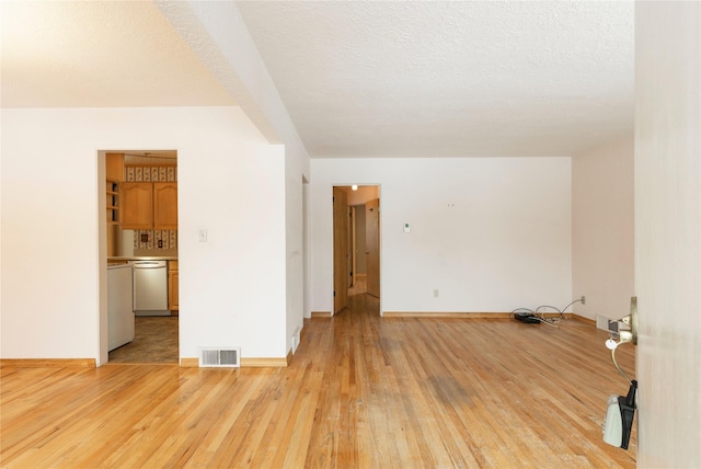 interior space with light hardwood / wood-style flooring and a textured ceiling