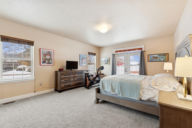 carpeted bedroom with french doors