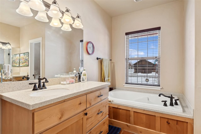 bathroom with a washtub and vanity