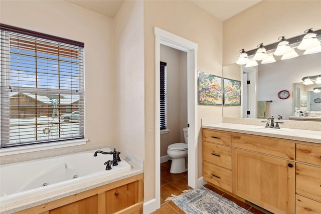 bathroom with vanity, a bathtub, and toilet