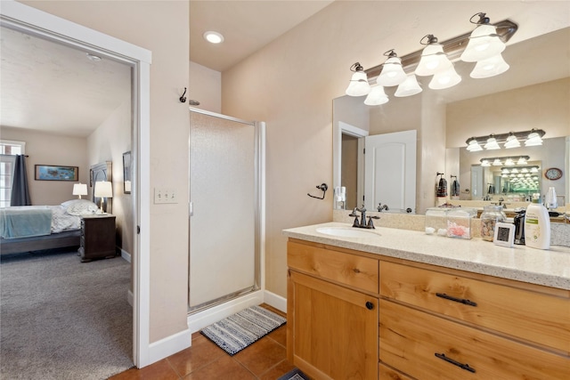 bathroom with tile patterned flooring, vanity, and a shower with door