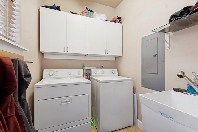 laundry area featuring cabinets, electric panel, sink, light tile patterned floors, and separate washer and dryer