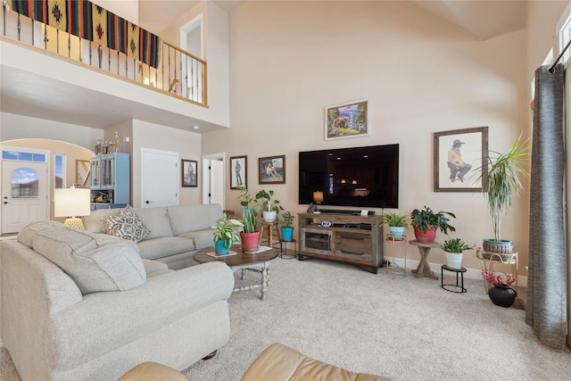 living room featuring carpet floors and a high ceiling